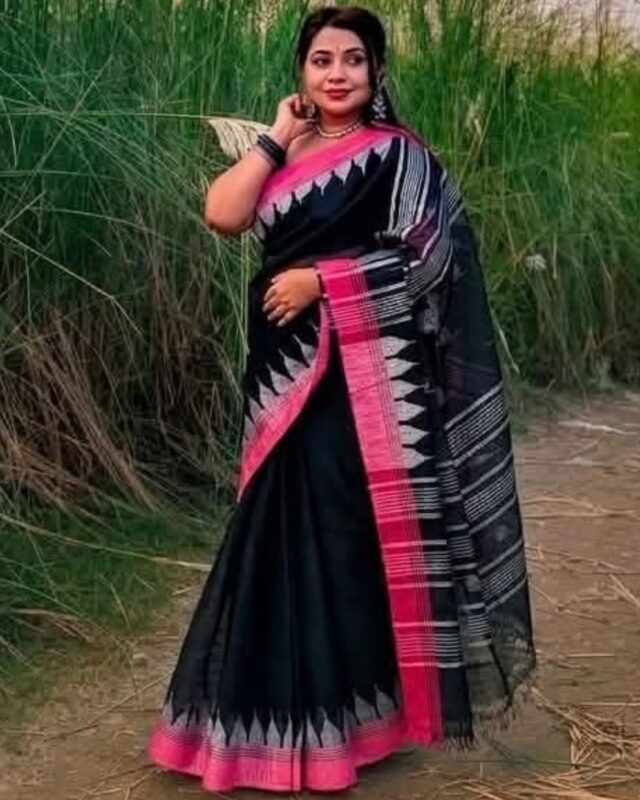 A professional website product photo displaying a beautiful handwoven black premium cotton Manipuri saree from Bilashini.